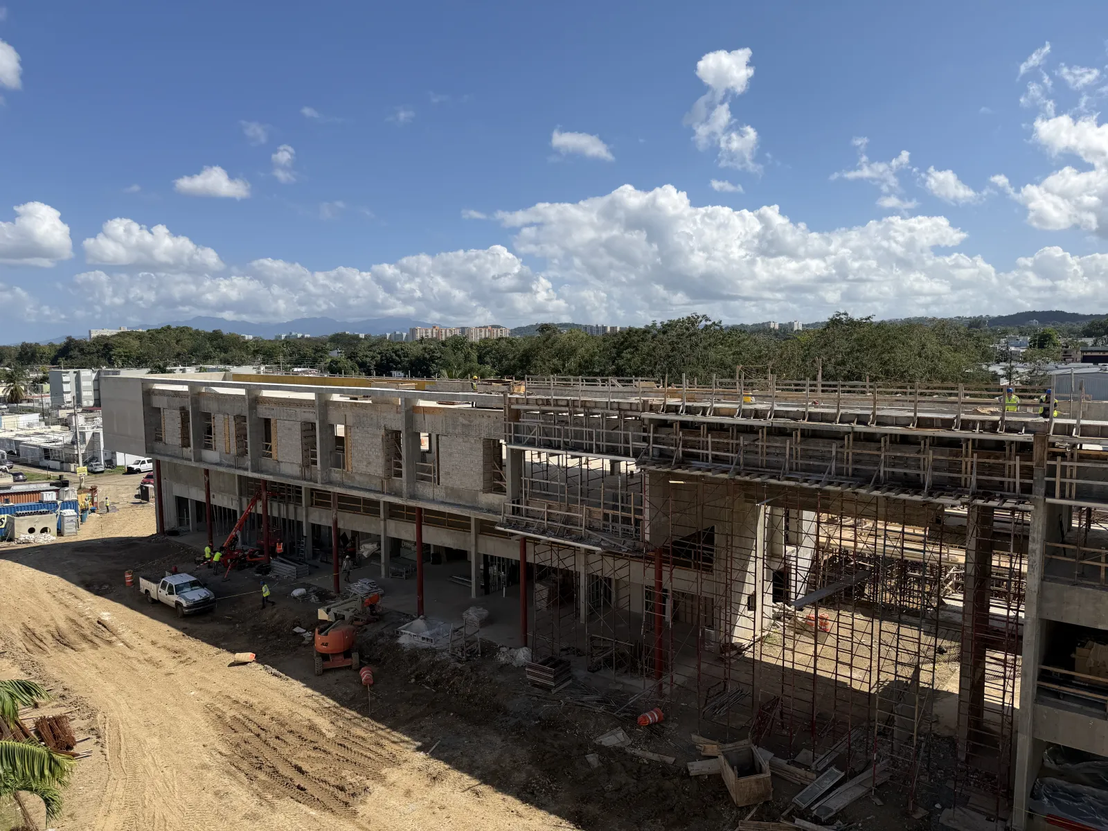 Wide elevated view of the Oasis Hub structure with scaffolding and a crane, February 2026