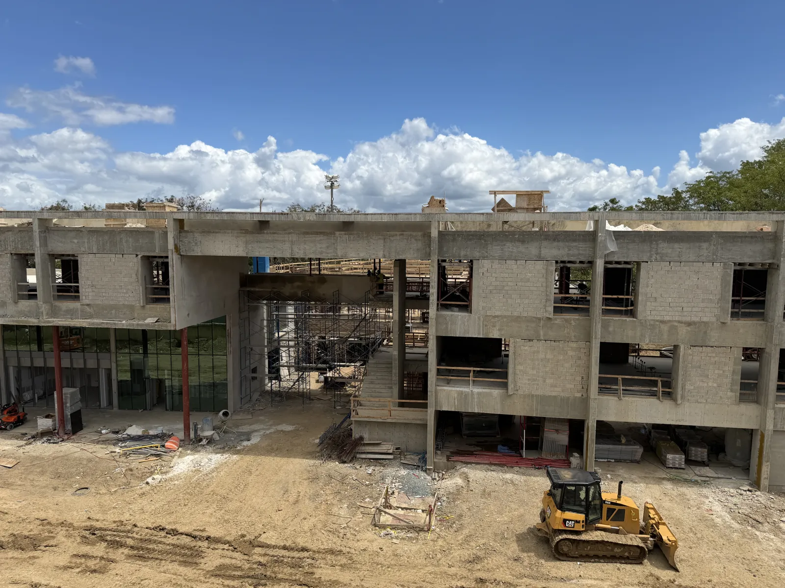 Elevated rear view of the Oasis Hub with envelope nearly closed and site prepped, May 2026